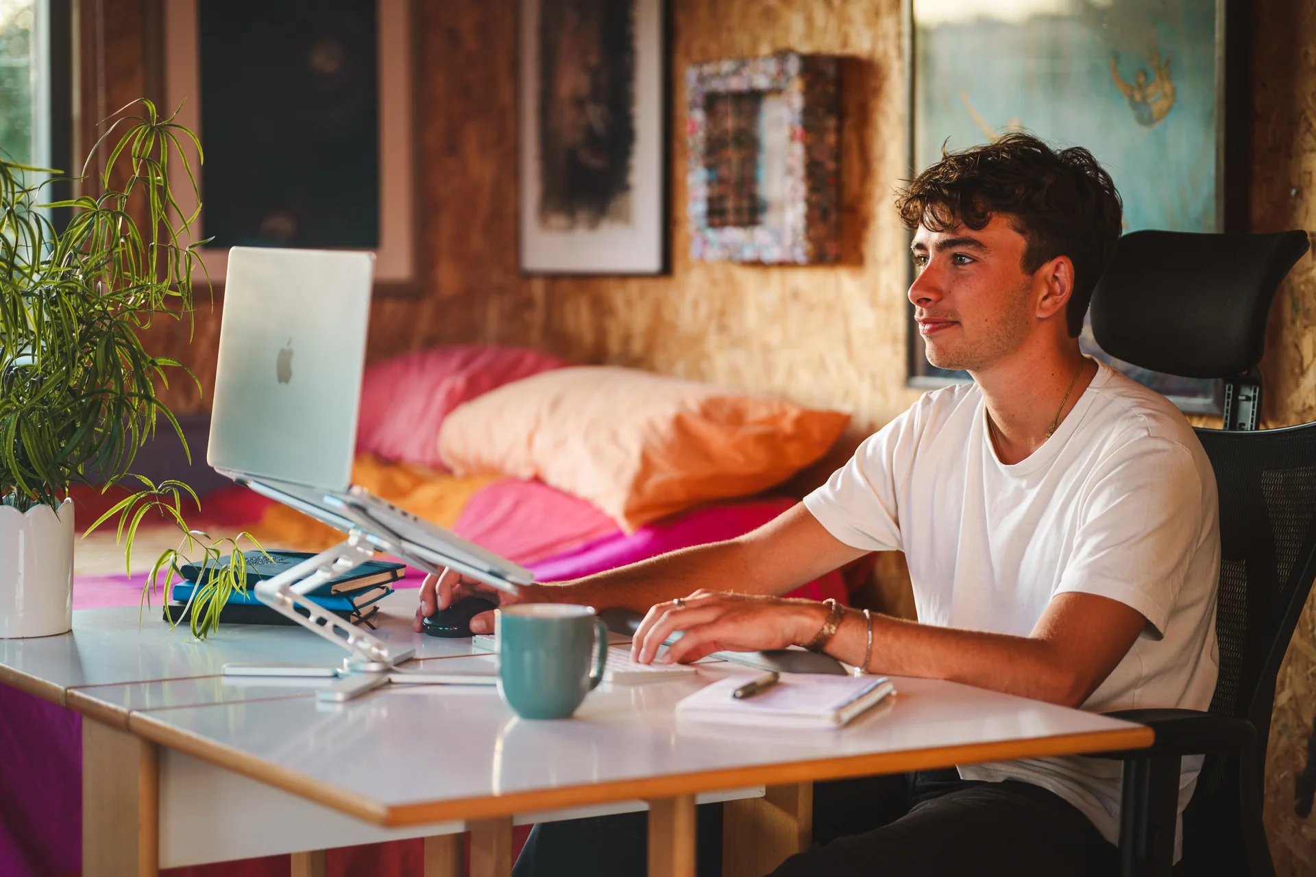 Tom Rowe working at his laptop in his studio